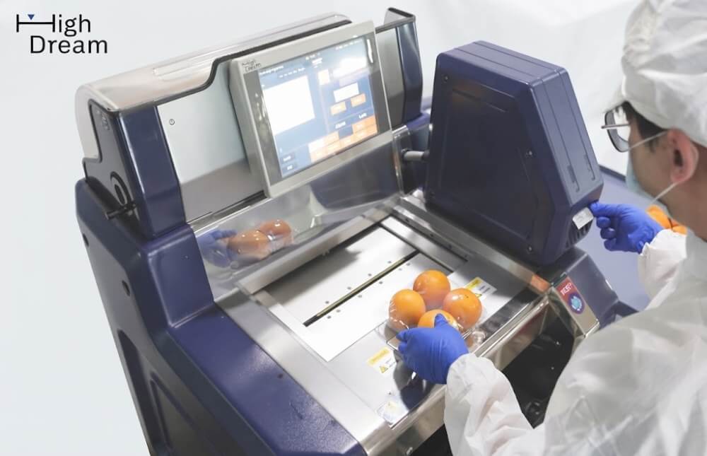 High Dream weigh-wrap-label machine packing fresh produce in a supermarket backroom
